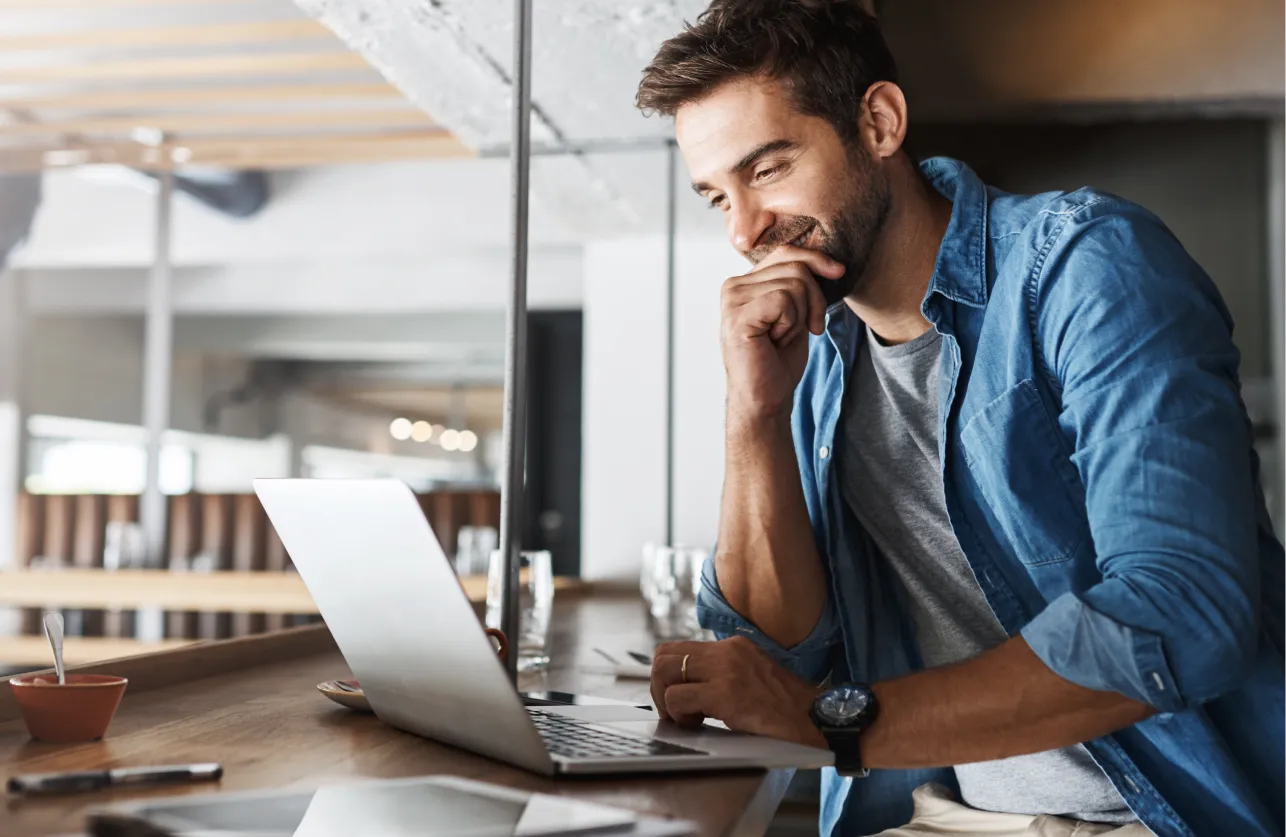 Hospitality operator reviewing foodservice rebates and purchasing data on laptop