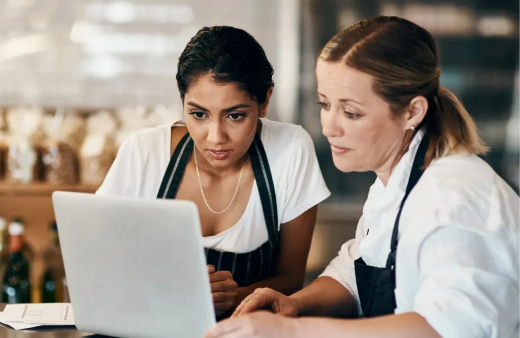 Restaurant managers reviewing purchasing and spend data to improve spend visibility